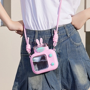 Detail of pink camera-shaped water bottle with bunny ears and adjustable woven strap