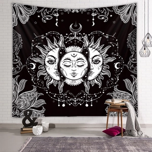Detail of bohemian sun and moon tapestry hanging on a vintage white brick wall