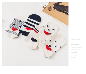 Close-up of five invisible low-cut socks with heart embroidery and polka dot patterns