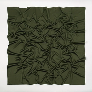 Detail of dark green matte satin square scarf showing soft silk texture and fabric folds