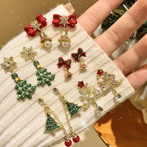 Christmas stud earring set with snowflakes, trees, pearls and crystals on white knit