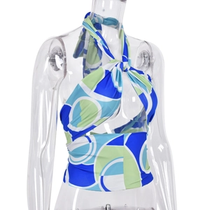 Detail of blue and green geometric swirl halter top with front knot and tie-neck design