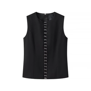Detail of black sleeveless vest with metal buttons and size M tag on neckline