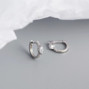 Macro shot of silver S925 earrings with marquise zirconia and sparkling small diamonds