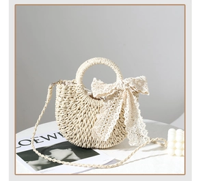 Close-up of beige woven straw handbag featuring a delicate white lace bow detail