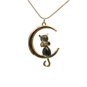 Golden crescent moon necklace with iridescent green cat pendant on box chain