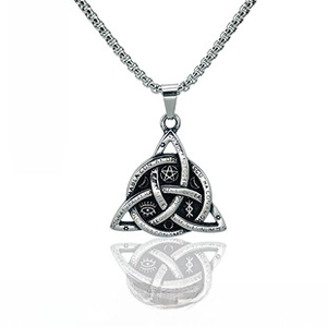 Macro detail of antique silver Celtic knot pendant with mystical symbols and square pearl chain