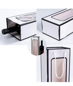 Detail of white wine gift bag with black trim, clear window and sturdy rope handle