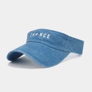 Detail of blue washed cotton visor featuring white embroidered CHANCE text and stitched brim