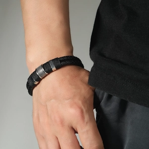 Men's double-layer black braided leather bracelet with silver magnetic buckle on wrist