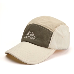Detail of embroidered mountain peak and EXPLORE text on two-tone five-panel camp cap