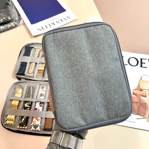 Grey fabric storage bag for Apple Watch bands and cables with elastic organizers