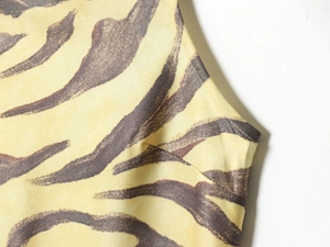 Detailed view of yellow zebra print fabric with precise stitching and dart construction