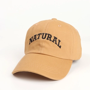 Close-up of black 'NATURAL' embroidery on khaki cotton twill baseball cap
