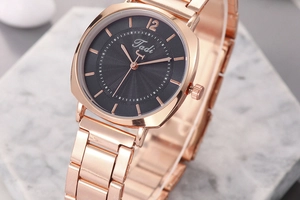 Detail of rose gold sunray dial and polished metal strap of the Tadi quartz watch