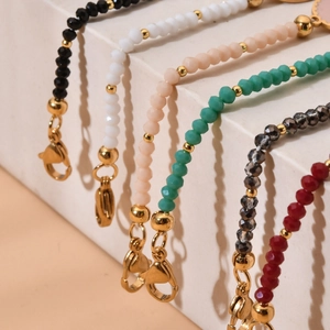 Detail of bohemian colorful crystal beads bracelets with gold star charms and lobster clasps