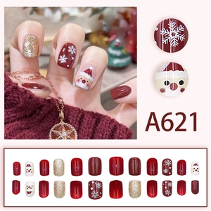 Short square Christmas press-on nails featuring Santa Claus and snowflake art designs