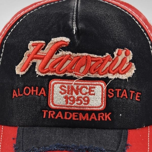 Close-up of vintage wash baseball cap featuring detailed Hawaii 3D embroidery and stitching