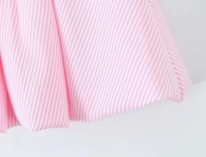 Detail shot of the pink and white striped fabric showing fine texture and draped waves