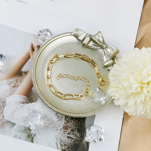 Detail of golden paperclip chain bracelet with lobster clasp and adjustable extender