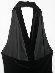 Close-up detail of the black velvet halter neck design on a luxury mini dress
