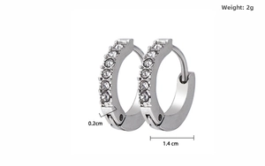 Macro detail of silver titanium hoop earrings with single row clear zircon stones