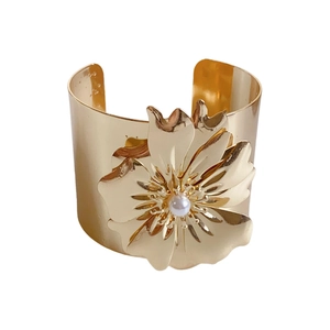 Gold-plated metal cuff bracelet with oversized flower motif and centered white pearl