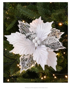 Close-up of white and silver glitter poinsettia flower on a decorated Christmas tree