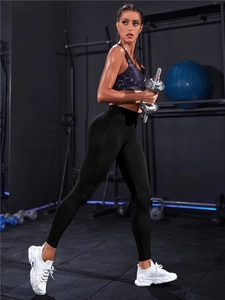 Detailansicht der High-Waist Yoga-Leggings und Marmor-Sport-BH im Fitnessstudio