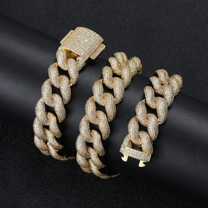 Close-up of gold iced-out Cuban chain and bracelet set with micro-pave zircons