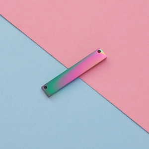 Macro view of rectangular rainbow plated stainless steel tag with double holes