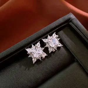 Square zircon snowflake starburst clip-on earrings in a black luxury leather box