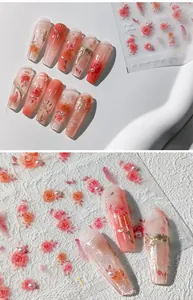 Macro detail of 3D rose nail decals with pearl accents and vintage lace textures