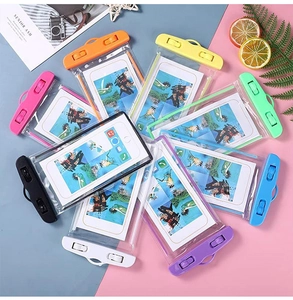 Flat lay of colorful waterproof phone pouches with lanyards for swimming and drifting