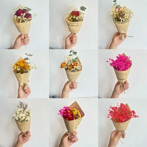 Various mini dried flower bouquets in newspaper wrapping with roses and baby's breath