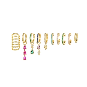 Flat lay of gold plated ear cuff and earring set with colorful crystal gemstones
