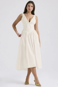 Detailed view of cream V-neck dress featuring corset waist and fine cotton texture