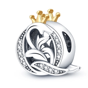 Detail of silver leaf charm with a golden crown and micro-pave sparkling cubic zirconia