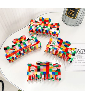 Macro view of colorful checkered heart-shaped hair claws in a 4-piece set collection