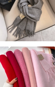Detailed view of stacked 100% Australian wool scarves with elegant fringe and labels