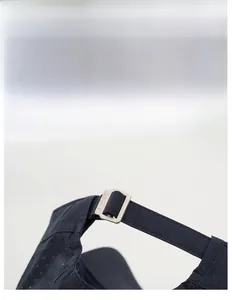 Detail of adjustable strap and SPORT buckle on a breathable navy blue outdoor cap