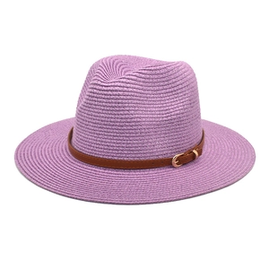 Detailed view of the woven purple Panama hat with a brown leather belt buckle strap