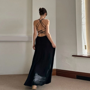 Detail of the cross back straps on a black silky backless maxi dress for women