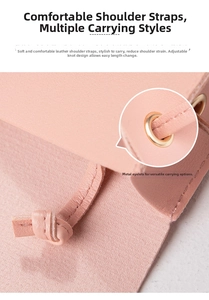 Detail of pink pebbled leather handbag with adjustable knotted strap and gold hardware