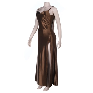 Detail view of the high side slit and smooth satin fabric drape of the brown evening dress