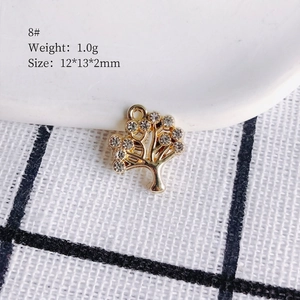 Macro detail of 12x13mm gold plated tree pendant with sparkling crystal rhinestone inlay