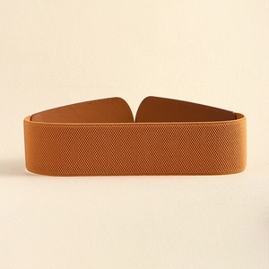 Close-up of tan elastic woven waist belt with brown leather accents on beige background