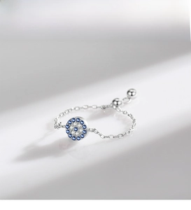 Macro shot of S925 sterling silver evil eye ring with blue cubic zirconia and sliding clasp