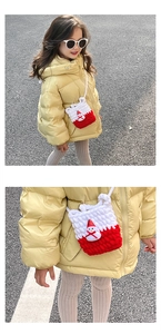 Detail of child's knitted Christmas snowman crossbody bag with red and white color scheme
