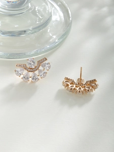 Close-up of fan-shaped stud earrings with teardrop zircon and gold-plated metal finish